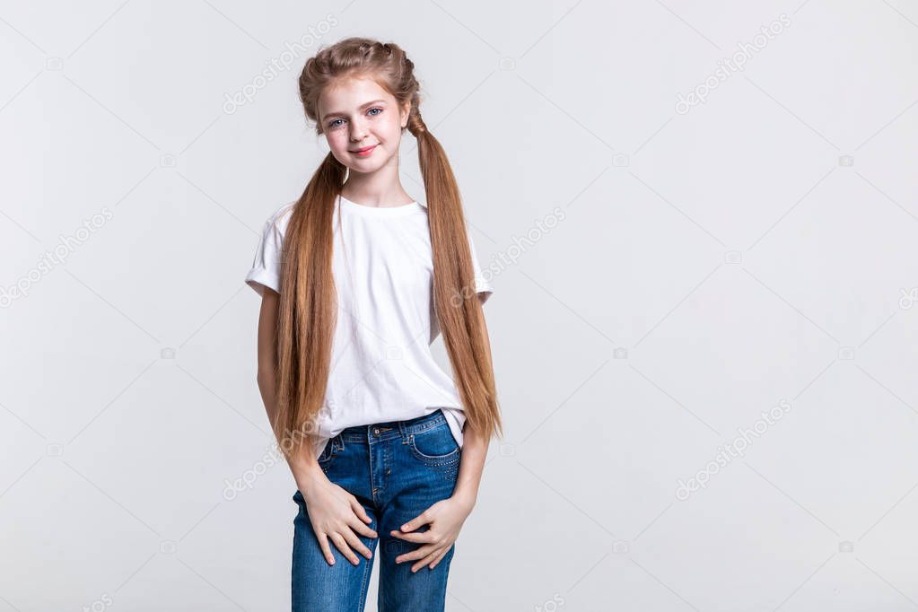 Pleasant calm girl lightly smiling while presenting her extra-long hair