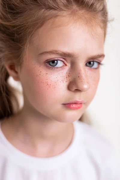 Affascinante giovane ragazza dai capelli chiari guardando da parte con grandi occhi blu — Foto Stock