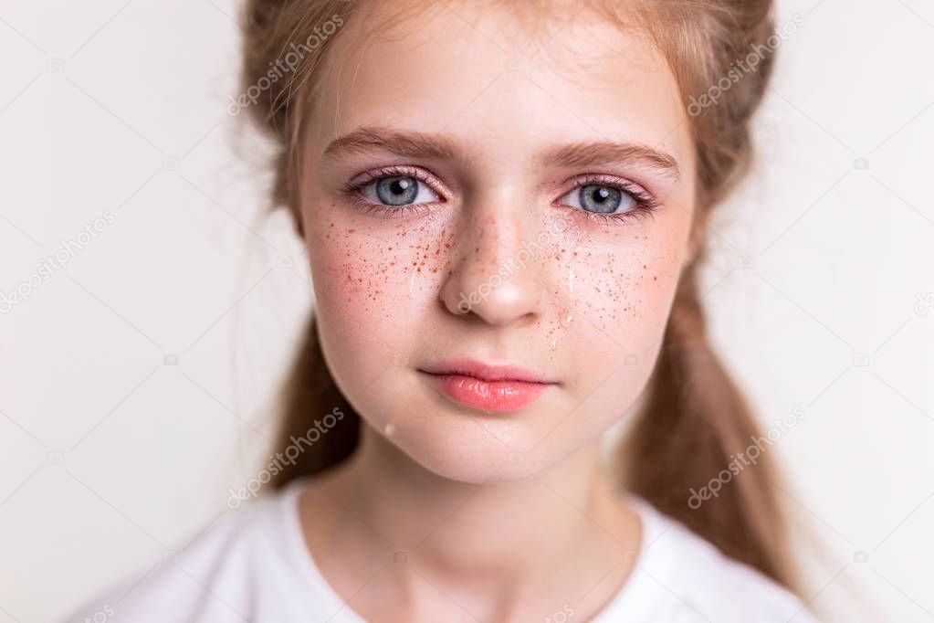 Appealing young lady with big blue eyes being in depressed mood