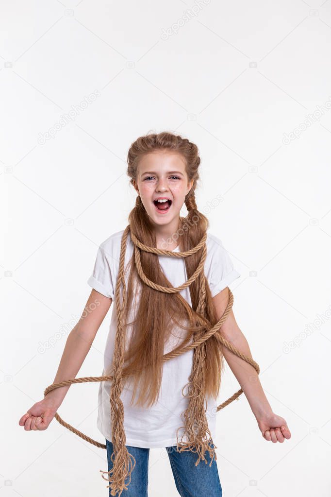 Screaming long-haired little girl having thick rope all around her