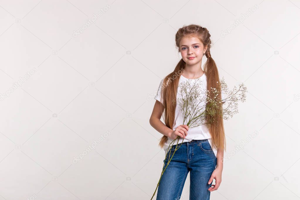 Skinny pretty girl with long light hair wearing blue jeans