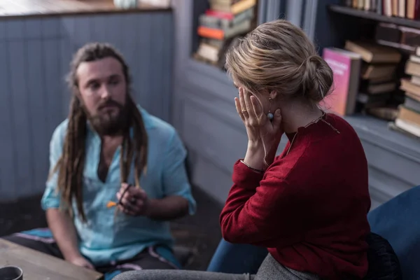 Beautiful worried blonde woman touching her cheek — Stock Photo, Image