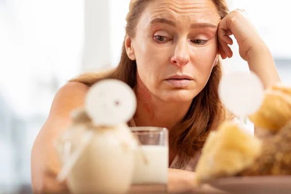 Close up of mature woman with facial wrinkles having food allergy — Stock Photo, Image