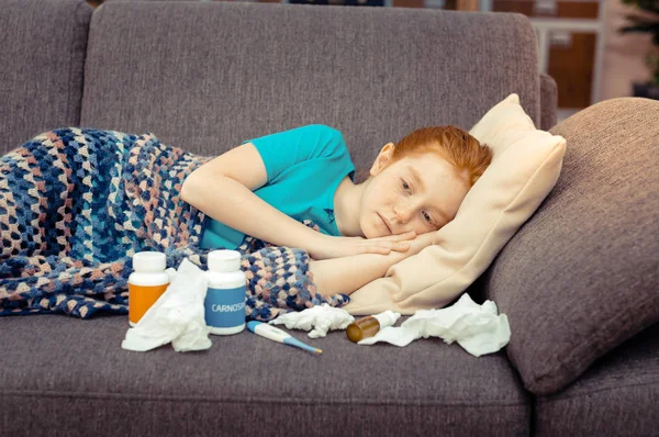 Sad unhappy girl lying on the sofa — Stock Photo, Image