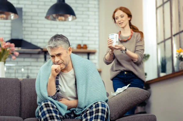 Sad cheerless man coughing into his fist — Stock Photo, Image