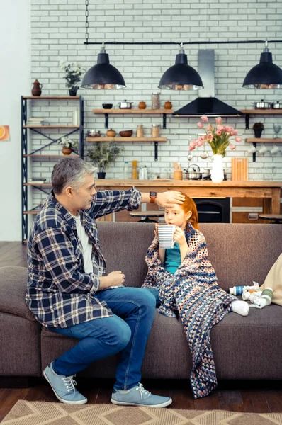 Nice good looking father touching her daughters forehead — Stock Photo, Image