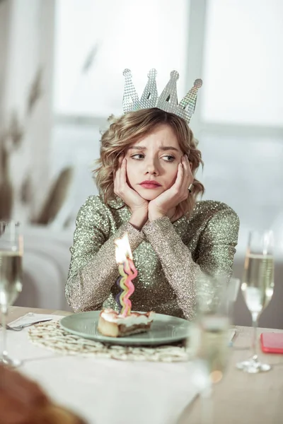 Young woman feeling unhappy on her birthday feeling lonely