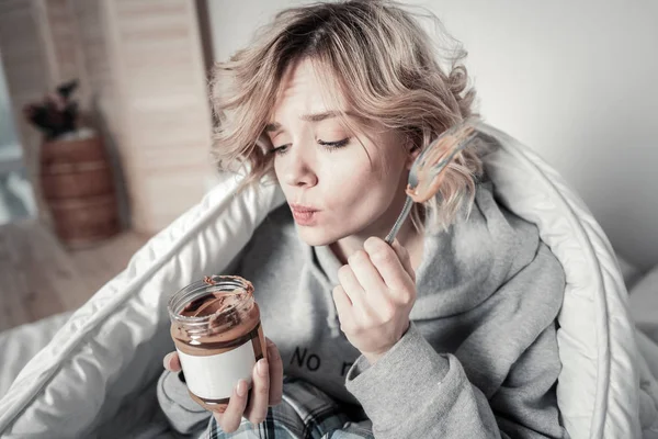 Mujer no va a ninguna parte y comer chocolate con cuchara — Foto de Stock