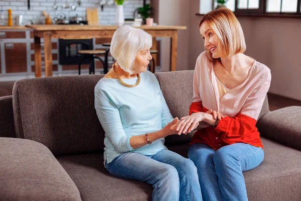 Elegant pensioner examining beautiful engagement ring of her relative — Stock Photo, Image