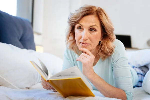 Thoughtful curious mature woman wearing comfortable domestic clothes — Stock Photo, Image