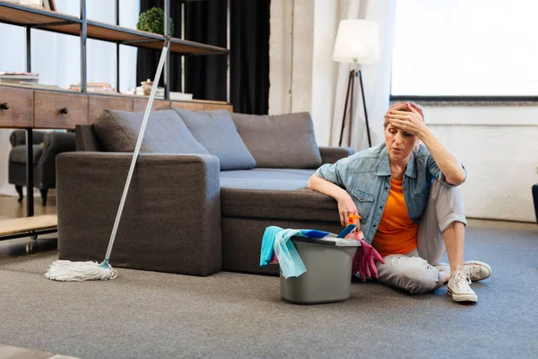 Mujer madura despedido siendo extremadamente cansado y descansando en el suelo — Foto de Stock