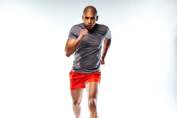 Sportsman wearing red suit doing running movements — Stock Photo, Image