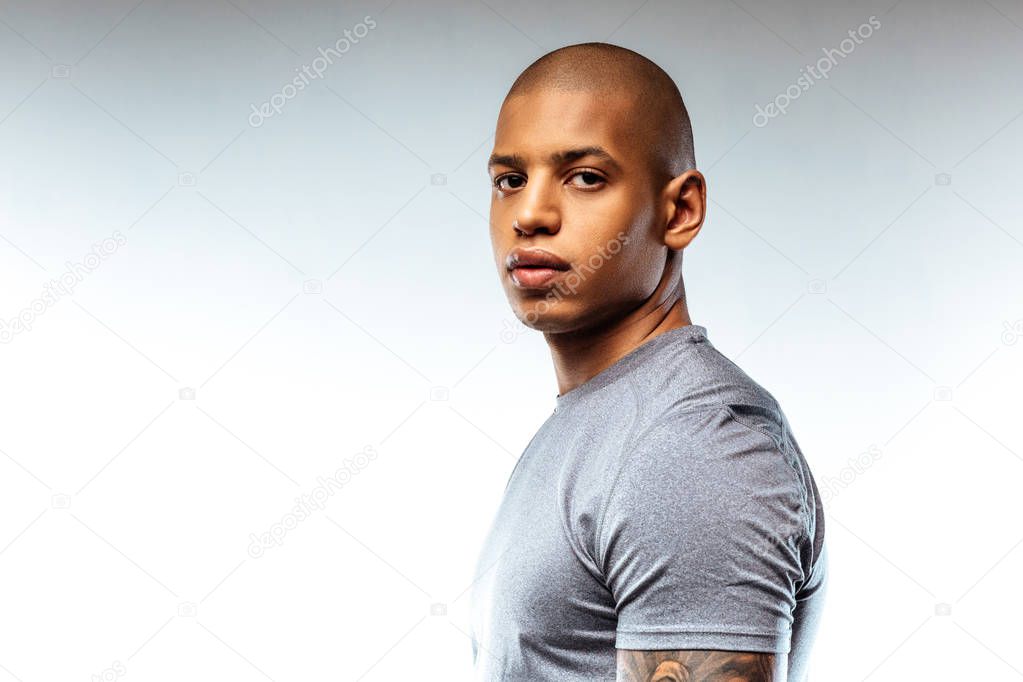 Sportive bold african-american man wearing sport t-shirt