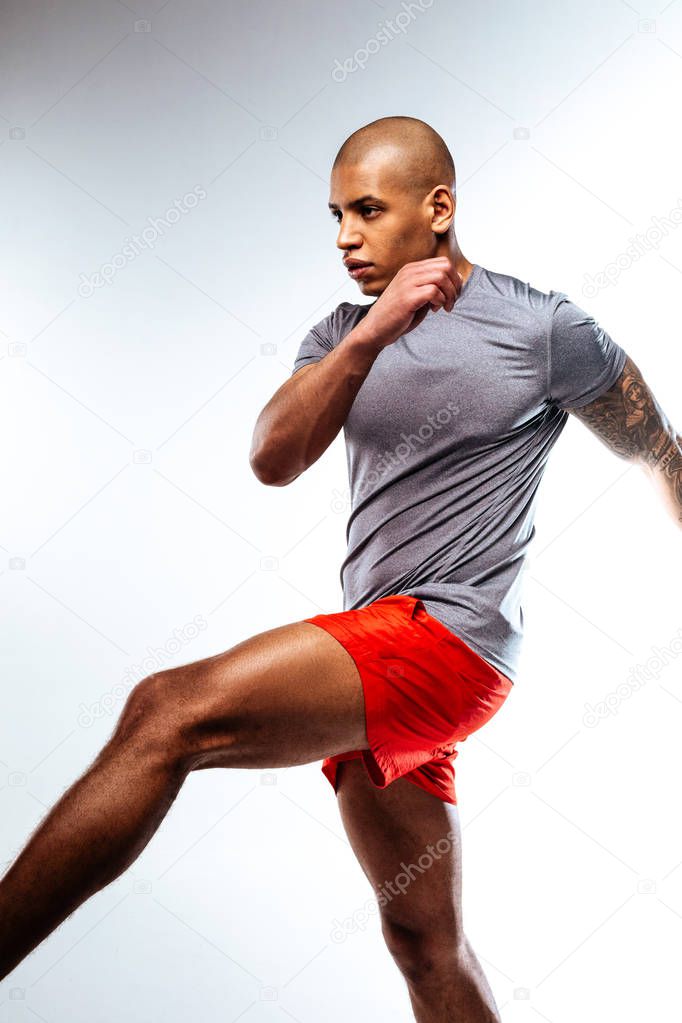 Sportive man doing a football player movements
