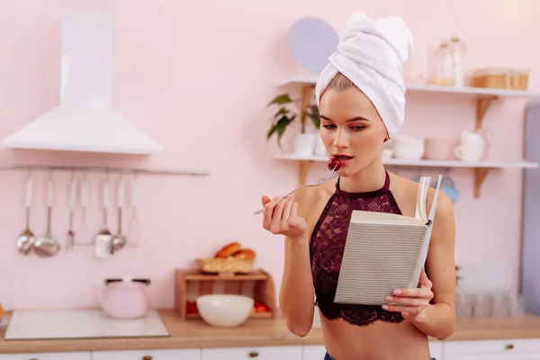 Busy businesswoman checking schedule while having breakfast