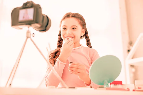 Joyful happy girl applying lipstick on her lips — Stock Photo, Image