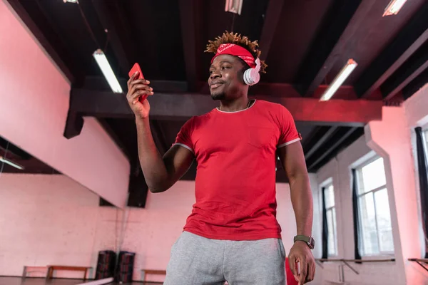 Smiling African American dancer being satisfied with music