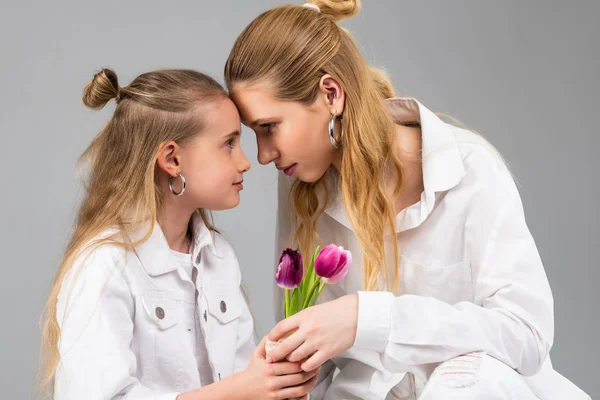 Resolute appealing woman connecting foreheads with her younger sister — Stock Image Resolute appealing woman connecting foreheads with her younger sister Stock Image