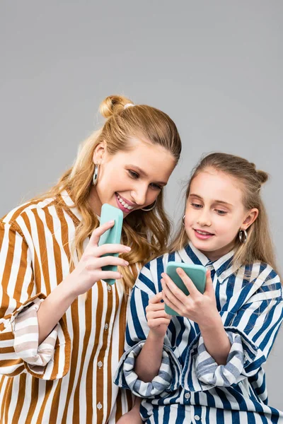 Laughing attractive woman showing interesting thing on smartphone screen — Stock Image Laughing attractive woman showing interesting thing on smartphone screen Royalty Free Stock Photos