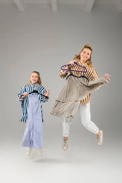 Cheerful young ladies being in great mood during trying on — Stock Image Cheerful young ladies being in great mood during trying on Stock Image