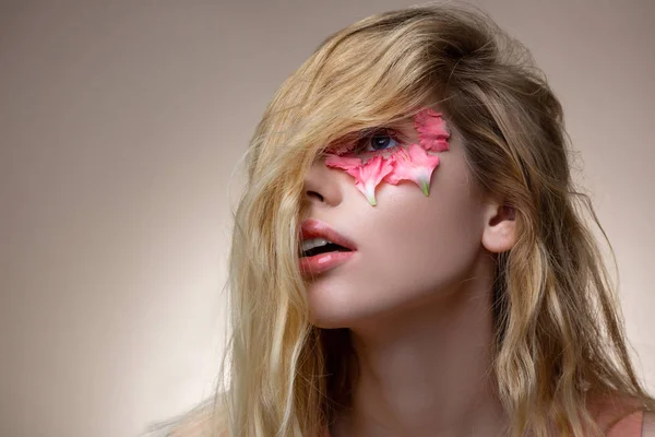 Tender young model having blonde wavy hair on her face — Stock Photo, Image