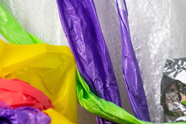 Colorful plastic materials hanging out from the wall