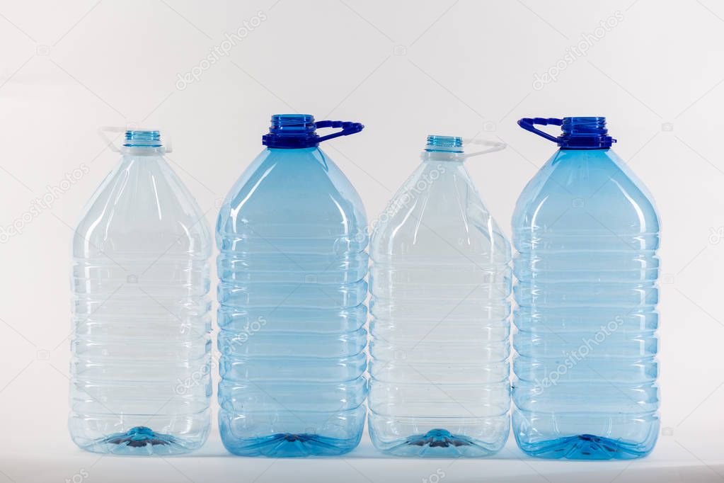 Bigger size clear water bottles standing in right row