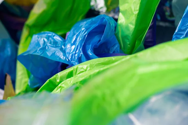 Bright toxic wraps and bags thrown in pile of crumpled plastic