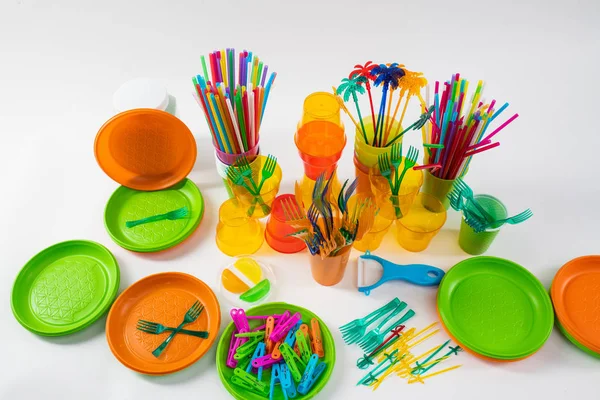 Colorful plates and bright pins lying with forks and straws around — Stock Photo, Image