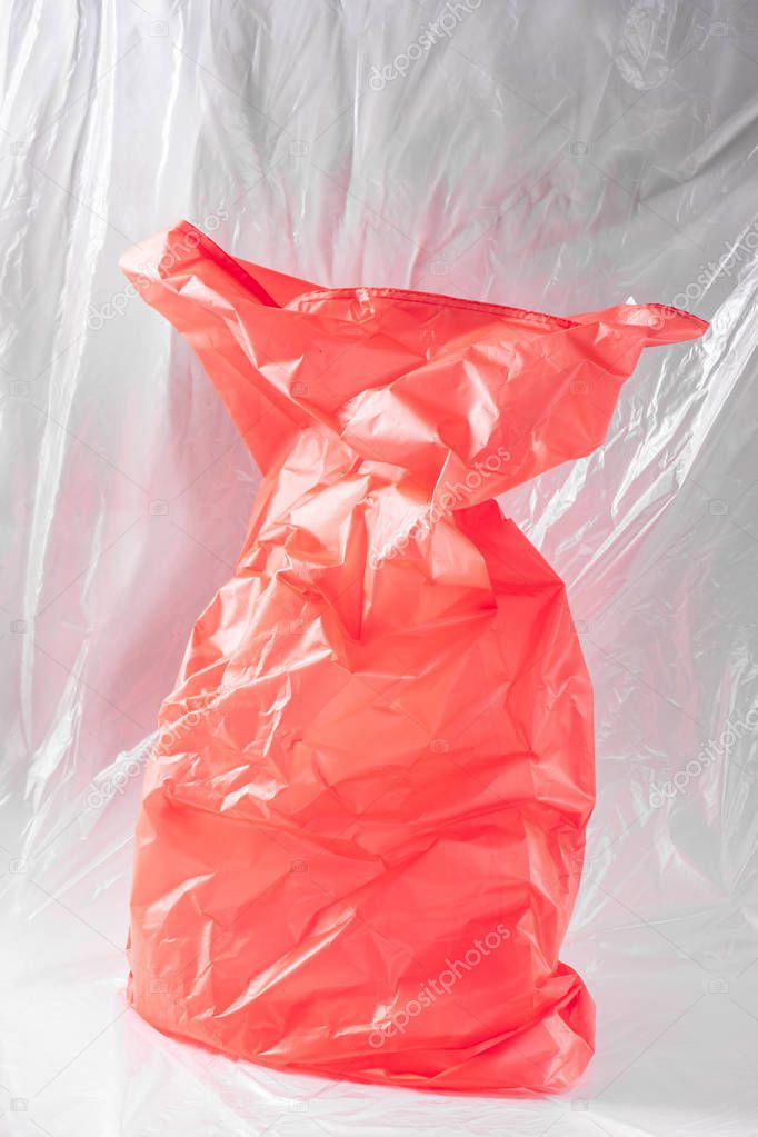 Bright red plastic bag placed in the middle of the studio