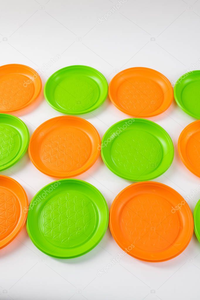 Green and orange bright toxic plates placed in right lines
