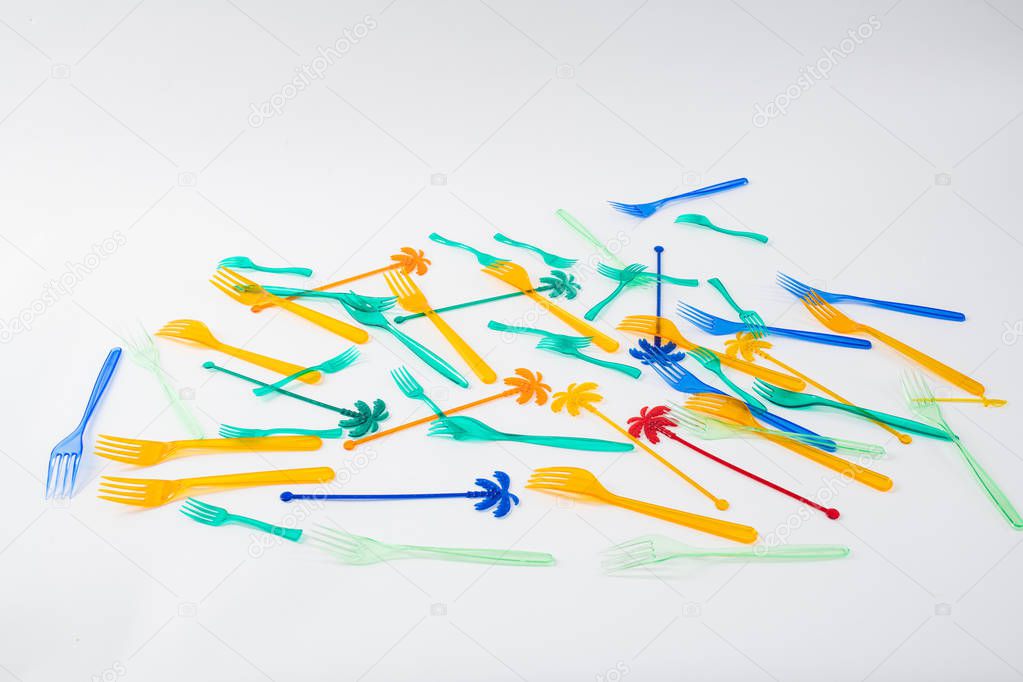 Bunch of colorful disposable forks and skewers chaotically lying