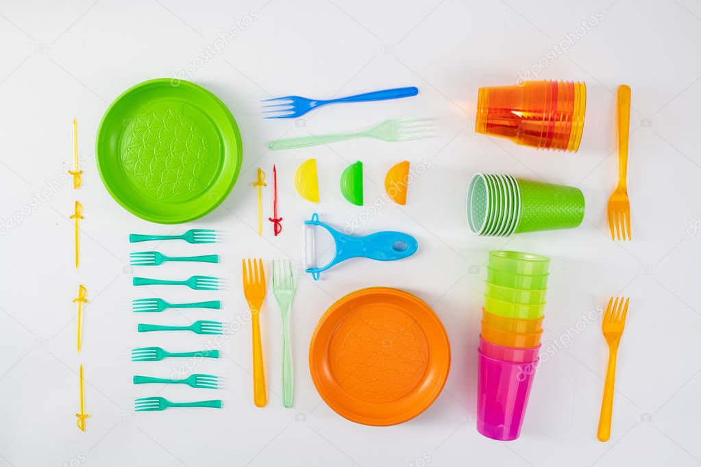 Bright plates and forks lying with skewers and cups
