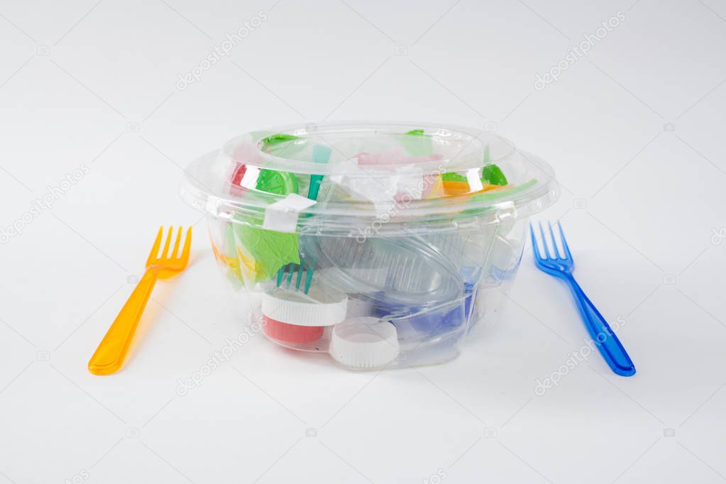 Harmful pile of plastic trash and pieces placed inside of transparent container