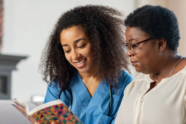 Close up of pleasant smiling nurse communicating with lady — Stock Photo, Image