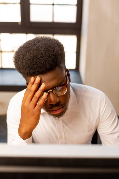 Serious African American man concentrating on his work