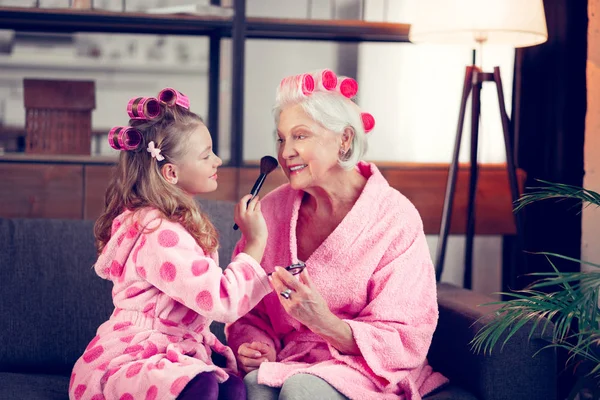 Meisje en oma dragen haar rollers make Makeup samen — Stockfoto