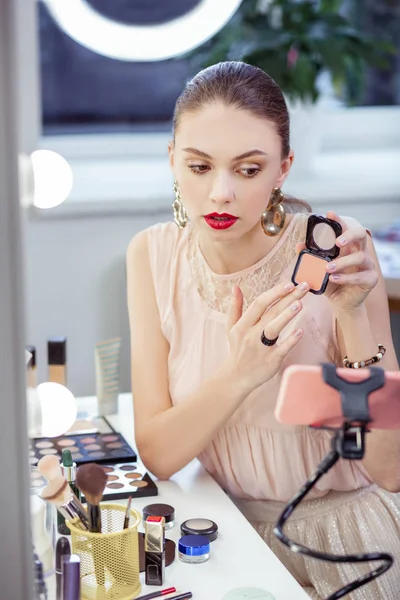 Pretty nice young woman showing her cosmetics — Stock Photo, Image
