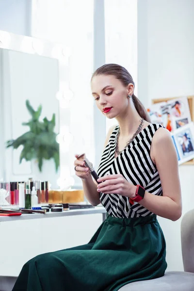 Delighted nice woman looking at the brush — Stock Photo, Image