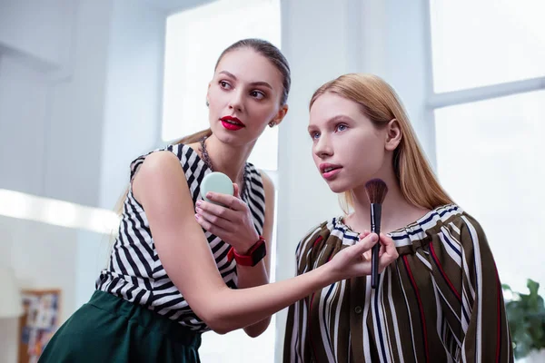 Pleasant nice young woman looking at herself — Stock Photo, Image