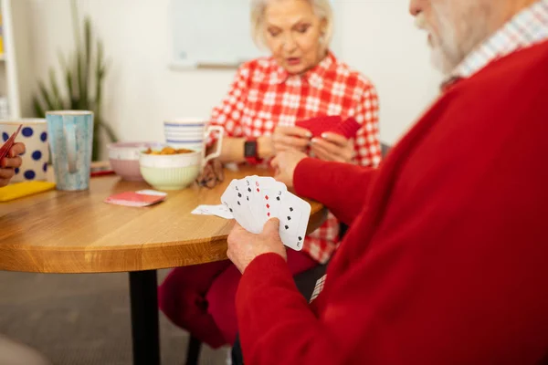 Different cards in an elderly mans hand — Stock Photo, Image