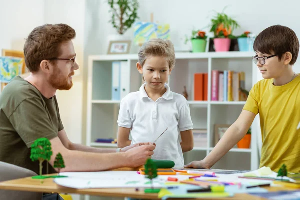 Attentive boys listening to their smart teacher during lesson — Stock Photo, Image