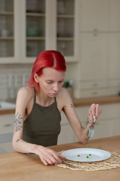 Red-haired woman suffering from anorexia eating nothing — Stock Photo, Image