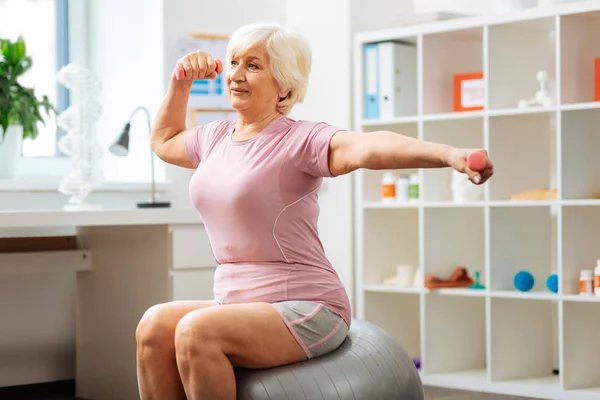 Pleasant active woman having a sports training