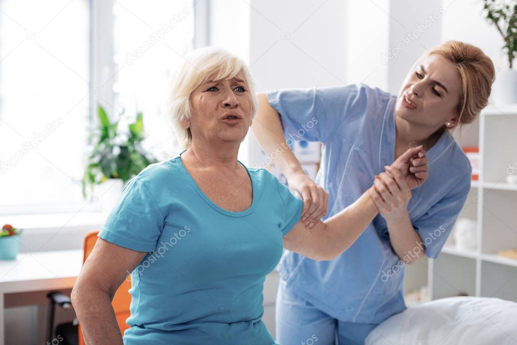 Nice aged woman having a painful massage