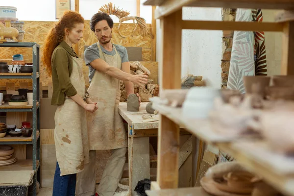 Slimme professionele aardewerk Master uitleggen proces naar attente vrouw — Stockfoto