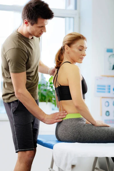 Nice dark haired man asking questions to his patient — Stock Photo, Image