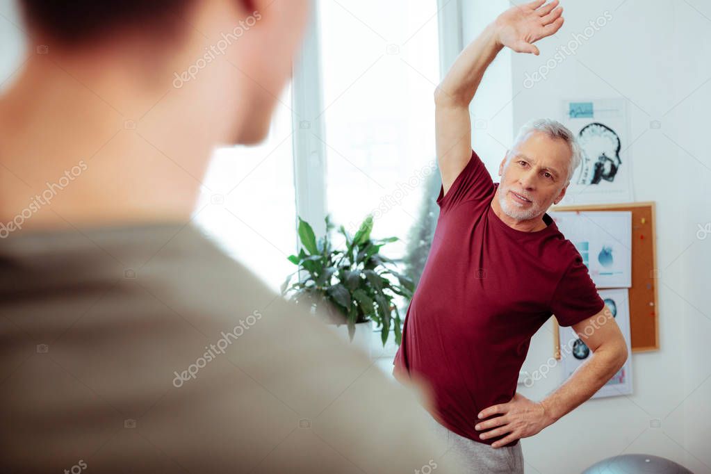 Pleasant aged man having a sports workout