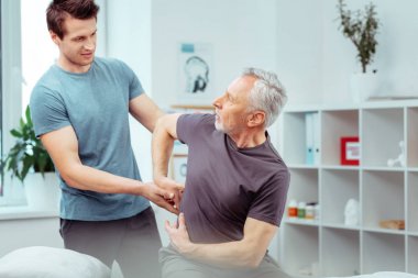 Hoş yaşlı adam acı bir yer gösteren