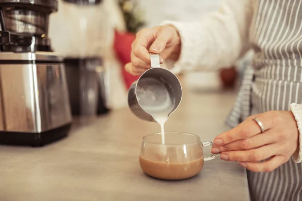 Pouring some milk into freshly brewed coffee. — Stock Photo, Image